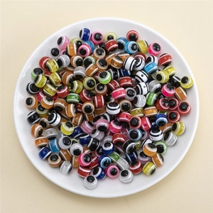 Colorful mixed resin evil eye beads for DIY jewelry making in a white ceramic bowl