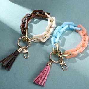 Detail view of acrylic chain keychains with colorful links and PU leather tassels