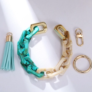Close-up of acrylic chain keychain with marble link tassel and gold metal hardware