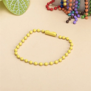 Close-up of bright yellow painted metal ball chain with connector for DIY accessories