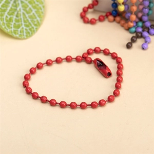 Detail of red painted metal bead chain with connector clasp against a colorful background