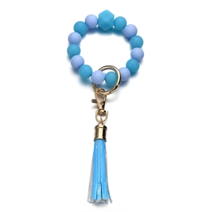 Bracciale portachiavi in perline di silicone viola con chiusura dorata e nappa blu