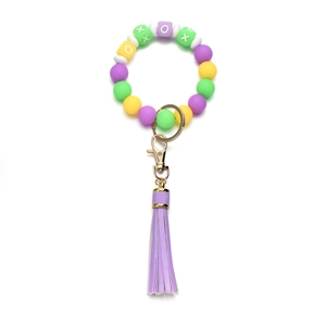 Detail view of colorful silicone beaded keychain with XOXO blocks and long purple tassel