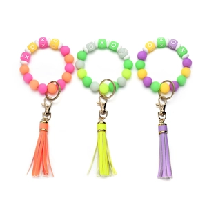 Luminous silicone bead keychain bracelet with XOXO letters and colorful leather tassel