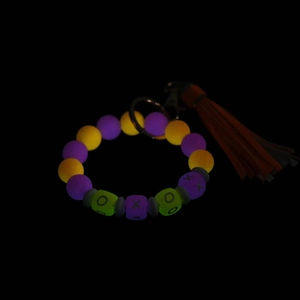Glow in the dark silicone bead bracelet keychain with orange tassel and silver clasp
