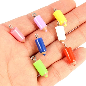 Colorful resin pencil-shaped pendants for DIY jewelry making held in hand