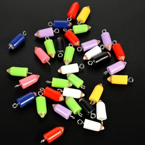 Macro detail of assorted colorful resin pencil charms for DIY jewelry making and crafts