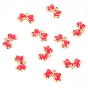 Set of ten red enamel bow charms with gold metal edges for DIY jewelry making