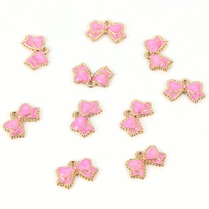 Detailed view of ten pink enamel bow charms with golden edges for DIY jewelry making
