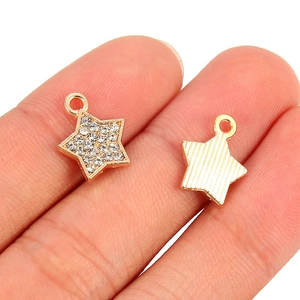 Golden star pendants with white crystals and striped back texture for DIY jewelry