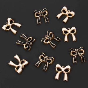 DIY gold plated enamel bow charms in black and white for jewelry making projects