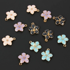 Detailed view of colorful oil-dripped flower charms for DIY jewelry making with gold edges