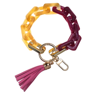 Close-up of acrylic link chain keychain with metallic gold ring and purple leather tassel