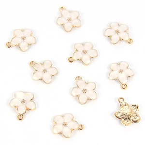 Detailed macro view of white enamel flower pendants with gold-plated metal alloy finish