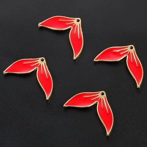 Close-up of red enamel and gold-plated leaf charms for DIY jewelry making accessories
