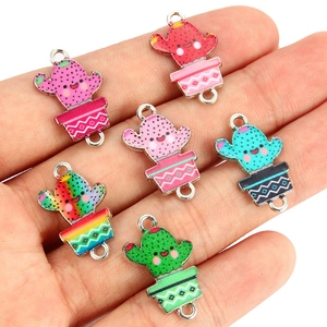 Detailed view of colorful enamel cactus charm connectors for DIY jewelry making