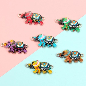 Detailed view of colorful elephant charms with bohemian patterns and dual metal connectors