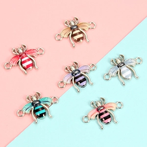 Macro detail of colorful enamel bee charms with silver alloy base for DIY jewelry making