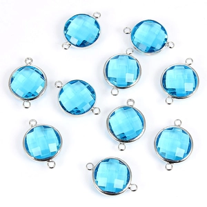 Macro of 20x15mm round faceted lake blue crystal charms with dual silver link rings