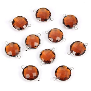 Detailed view of ten amber round faceted glass crystal charms with silver metal frames