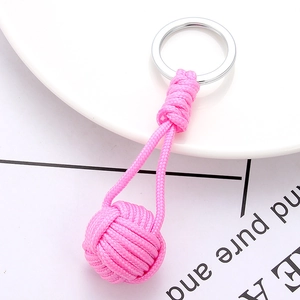 Detail of pink handmade woven keychain with monkey's fist knot and silver metal ring