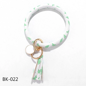 Close-up of PU leather O-ring keychain with cactus print, tassel, and gold clasp
