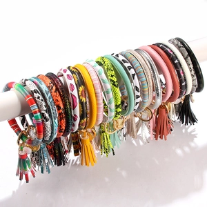 PU leather bangle keychain wristlet with tassel charms in multiple stylish patterns