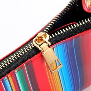Macro detail of colorful striped PU leather wristlet with golden metal zipper slider