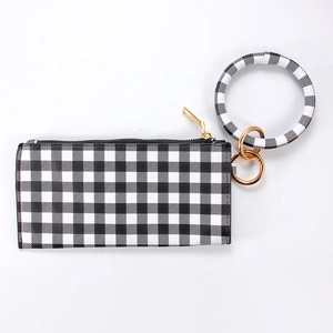 Close-up of black and white gingham PU leather clutch with golden zipper and bangle ring