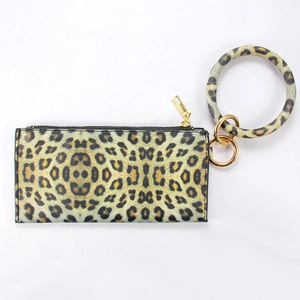 Detail of leopard print wristlet wallet with round handle and gold hardware zipper
