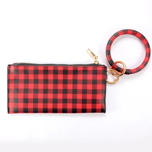 Detail of red and black buffalo plaid wristlet wallet with a gold zipper and ring handle