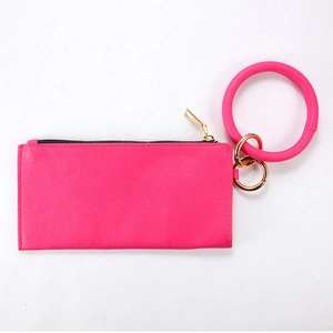 Close-up of rose red PU leather pouch with large bangle keychain and gold zipper hardware