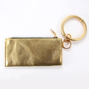 Detail view of gold PU leather clutch bag with large wristlet ring and secure zipper top