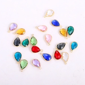 Detailed view of faceted teardrop glass pendants with gold metal edge for DIY jewelry making