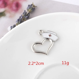 Detailed view of alloy heart nurse hat pendant with enamel cross and dimensions