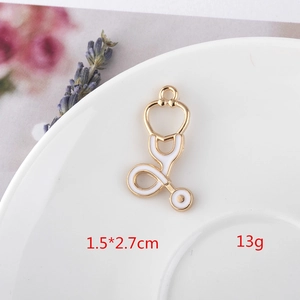 Macro detail of a gold and white stethoscopy pendant for DIY jewelry making