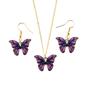 Detailed close-up of a gradient purple and blue enamel butterfly jewelry set with gold chain