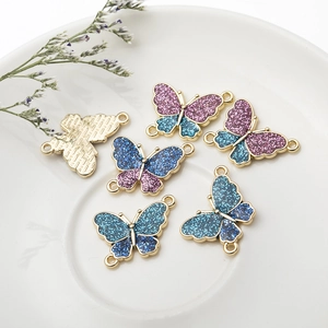 DIY glitter butterfly charms with purple and blue gradient enamel and double gold loops