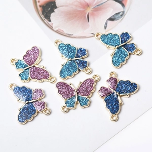 Glitter butterfly connectors for DIY jewelry making in blue and pink tones with gold borders