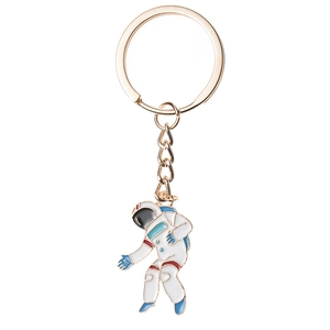 Detail van de gouden astronaut sleutelhanger met wit emaille en blauwe accenten