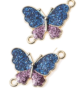 Detailed macro of gold-plated butterfly connectors with blue and purple glitter for DIY jewelry