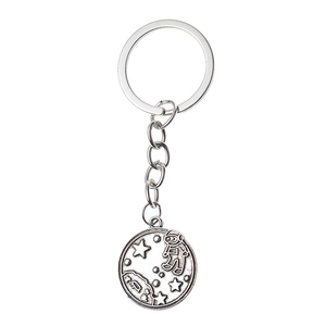 Detailed relief of an astronaut and planets on an antique silver metal keychain