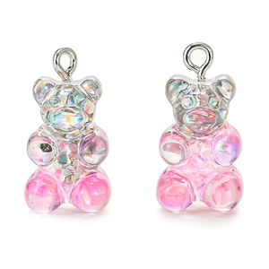 Detail of pink glitter resin gummy bear charms for DIY jewelry with silver eyelet hooks
