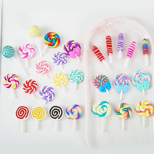 Colorful polymer clay lollipop pendants set for DIY jewelry making on marble tray