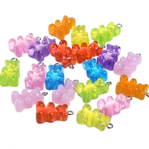 Close-up of colorful resin gummy bear pendants with silver metal rings for DIY jewelry