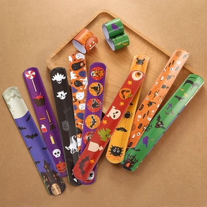 Overhead view of assorted Halloween snap bracelets featuring ghosts, pumpkins and bats