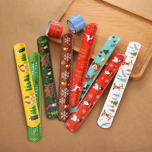 Close-up of festive slap bracelets featuring colorful Christmas patterns and cartoon designs
