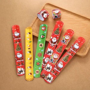 Detailed view of colorful Christmas snap bracelets with Santa and tree motifs