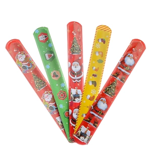 Detailed view of five Christmas slap bracelets with Santa and snowman patterns