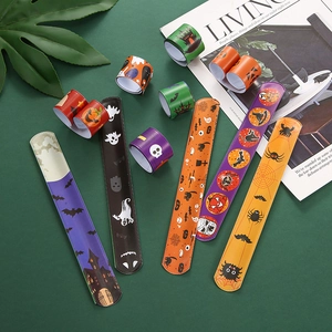 Halloween snap bracelet set with colorful pumpkin and ghost patterns on green background